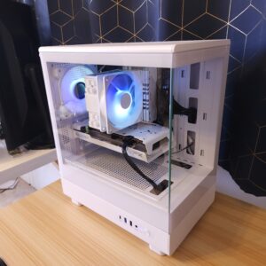 White custom gaming PC with blue RGB lighting, Radeon graphics card, and glass side panel, built in a micro-ATX case. View from the upper side.