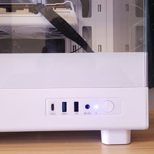 White custom gaming PC with blue RGB lighting, Radeon graphics card, and glass side panel, built in a micro-ATX case. View of side case connections USB and audio.